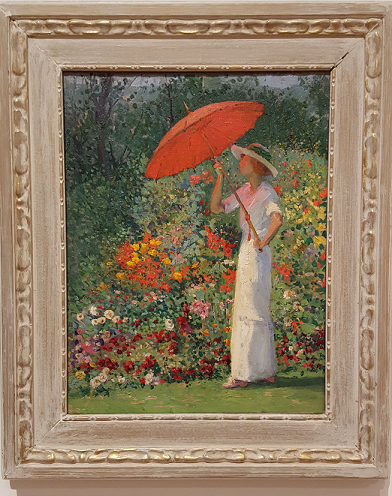 Women in white dress holding red parasol